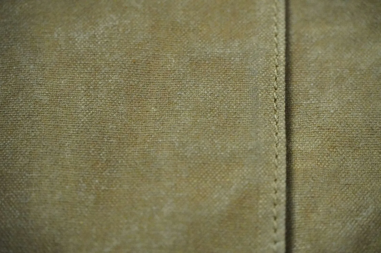 Close-up of luxury sofa fabric showing weave depth, stitching, and material quality